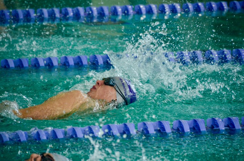 Royals senior Cole Parker has an early lead in the backstroke.
