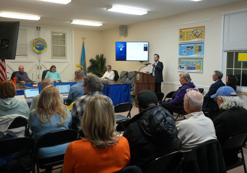 Attorney Glenn Mandalas speaks at the podium at a Dewey Beach Board of Adjustment hearing Dec. 17. The board and community members listen. ELLEN MCINTYRE PHOTO