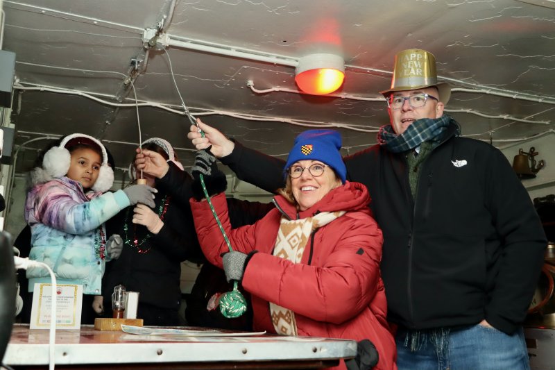 Lewes Mayor Amy Marasco, left, and Sen. Russ Huxtable ring the ship’s bell at 7 p.m. to coincide with midnight in Lewes, England.