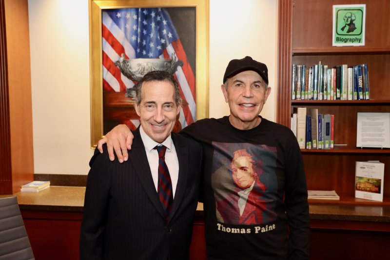 Ron Collins, right, sports a Thomas Paine T-shirt for the reception with Rep. Jamie Raskin.