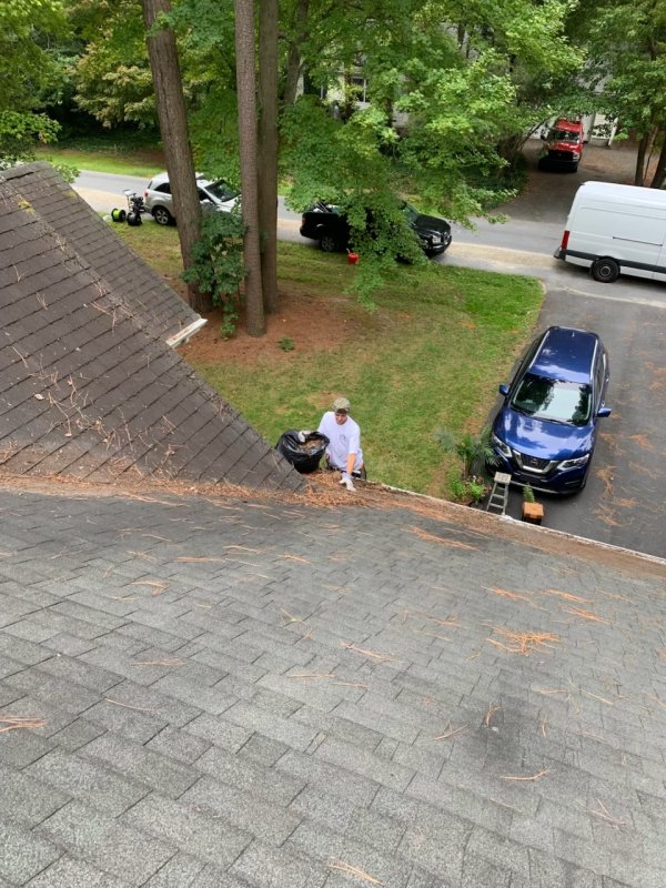 Luke Drager cleaning gutters for a client.
