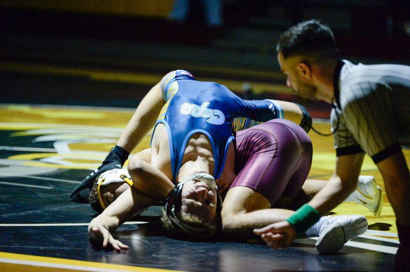 Carson Tuer gets tech falled by Milford’s Davonne Dallas.