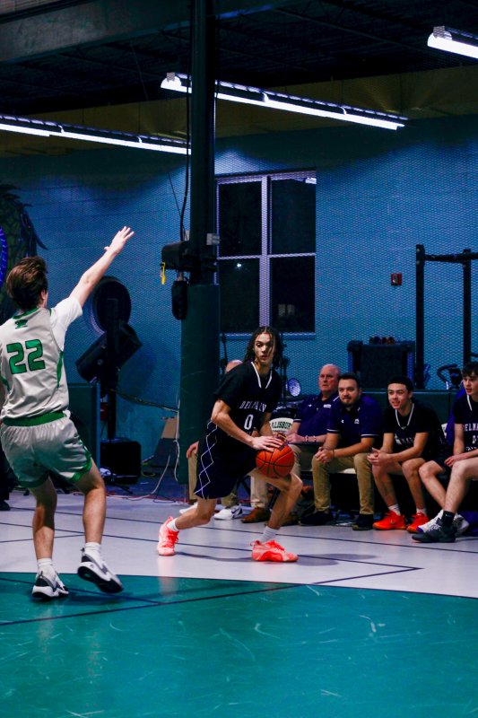 Delmarva Christian senior Seth Mifflin begins to drive inside after faking a shot on the outside.
