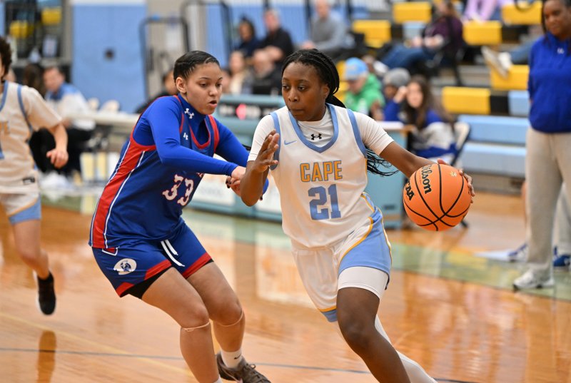 Cape senior Jurnee White drives to the paint on Dover’s Sarai Herford.