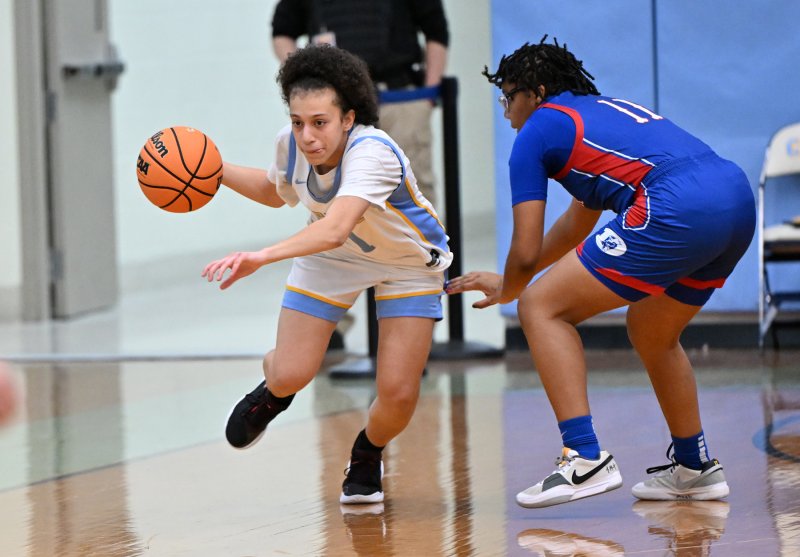 Cape senior Erinn Rodriguez takes off past Dover’s Auriana Moore on a fast break.