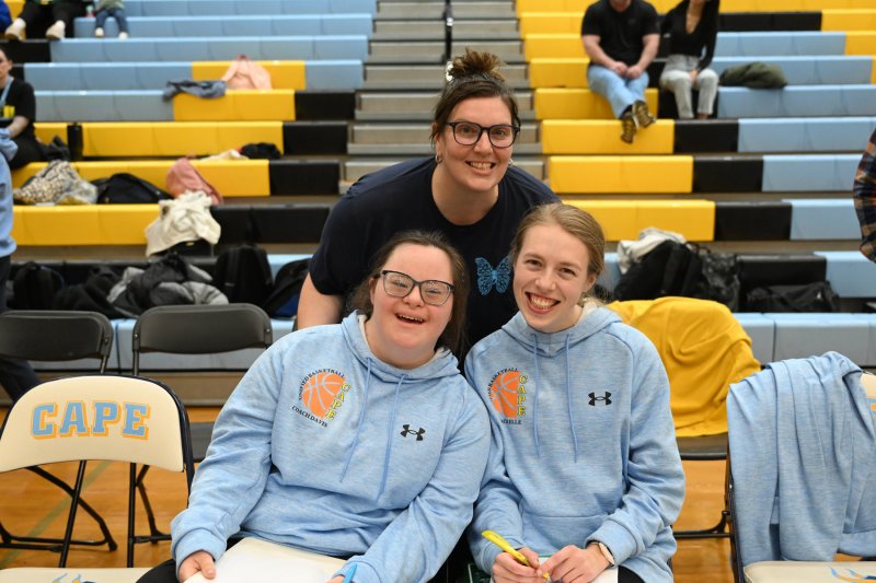 Cape coach Katie Collick, center, shares a moment with assistant coaches Sara Davis, left, and Elle Nauman.