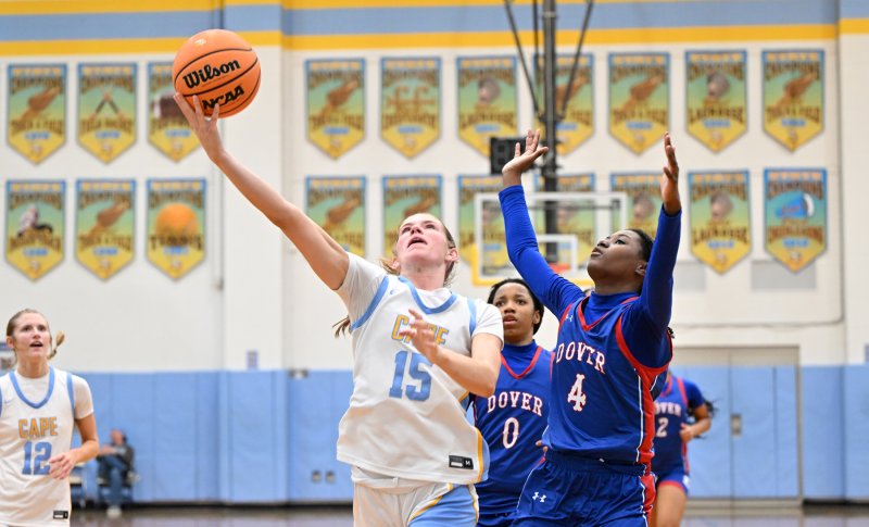 Cape senior Amalia Fruchtman lays in a finger roll past Dover’s Yasira Powell in the 74-20 win over the Senators. She tallied 21 points in Cape’s final regular-season contest. DAN COOK PHOTOS