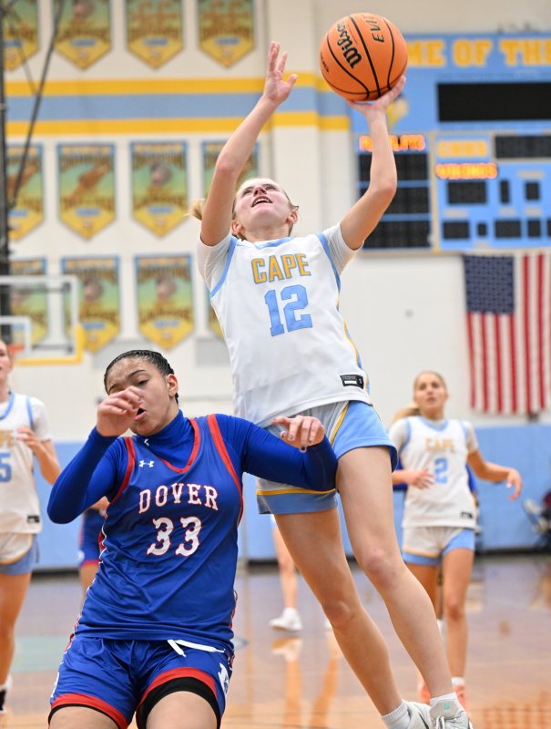 Junior Amara Fruchtman goes in with a lefty over Dover’s Sarai Herford.