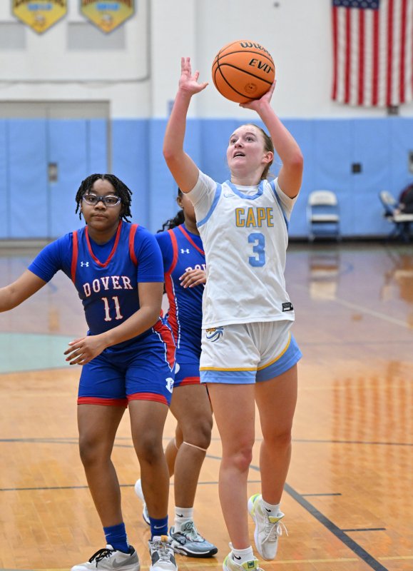 Junior Mairead Rishko takes a shot in the paint by Dover’s Auriana Moore.