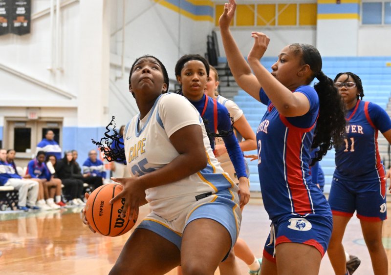 Sophomore Jordynn Bowe goes in strong on Dover’s Thalia Duverger for a basket.