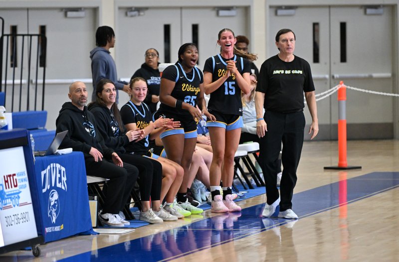 The Cape bench celebrates a shot by senior Maya Yngve.