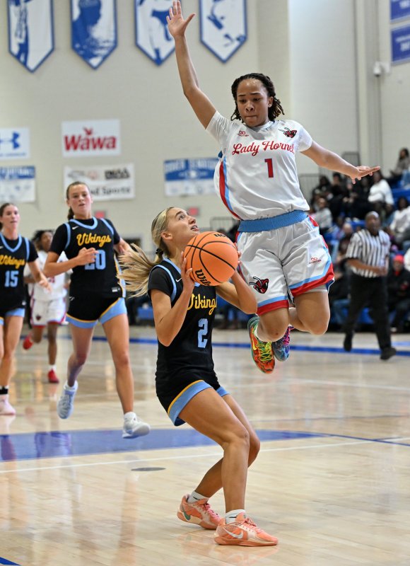 Cape sophomore Mikaela Gordon puts on the breaks and hits thew basket behind ECS’s Marshay Brown.