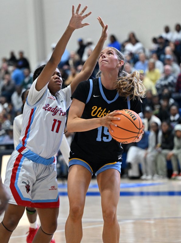 Senior Amalia Fruchtman hits a shot over Early College’s Jayla Dukes.