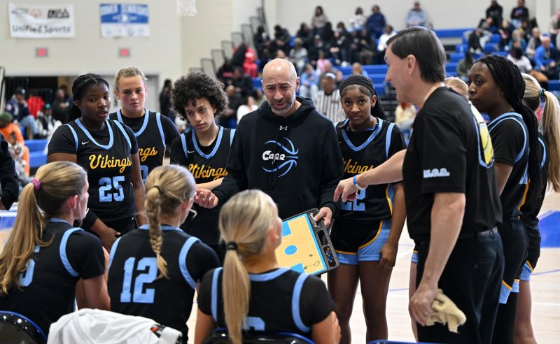 Cape coaches John Gordon, left, and Ron Dukes reviews a play for the fourth quarter.