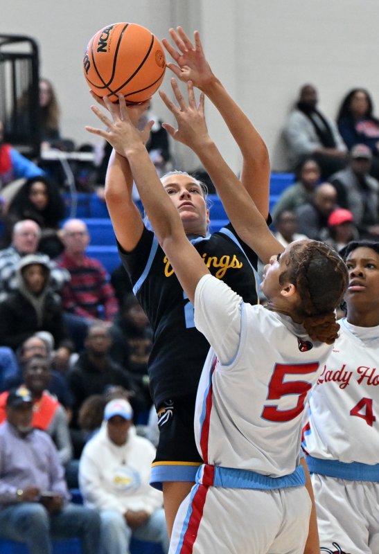 Ally Diehl hits with Early College’s Jayla Dukes in her face.