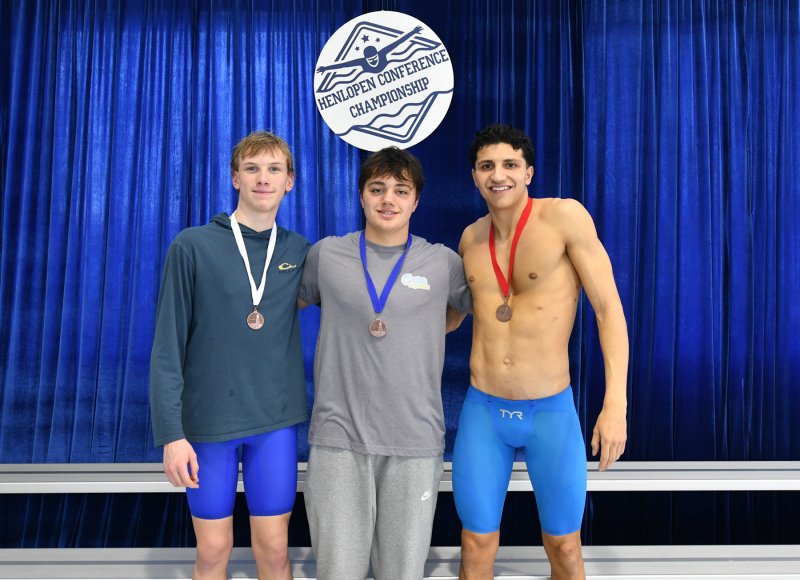 On the podium in the 100 butterfly are (l-r) third-place finisher Michael Whitaker of Sussex Academy, winner Jaxen Edwards of Cape and runner-up Christian Wright of Sussex Academy.