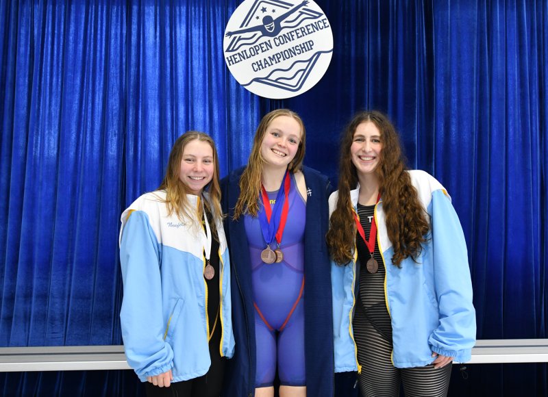 On the podium for the 500 free are (l-r) third-place finisher Zoey Neufeld of Cape, winner Anna Mumford of Sussex Academy and runner-up Hayden Hazzard of Cape.