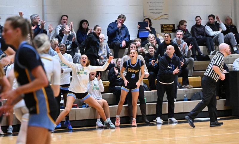 The Cape bench celebrates a made shot by Jordynn Bowe in the last minute of play.