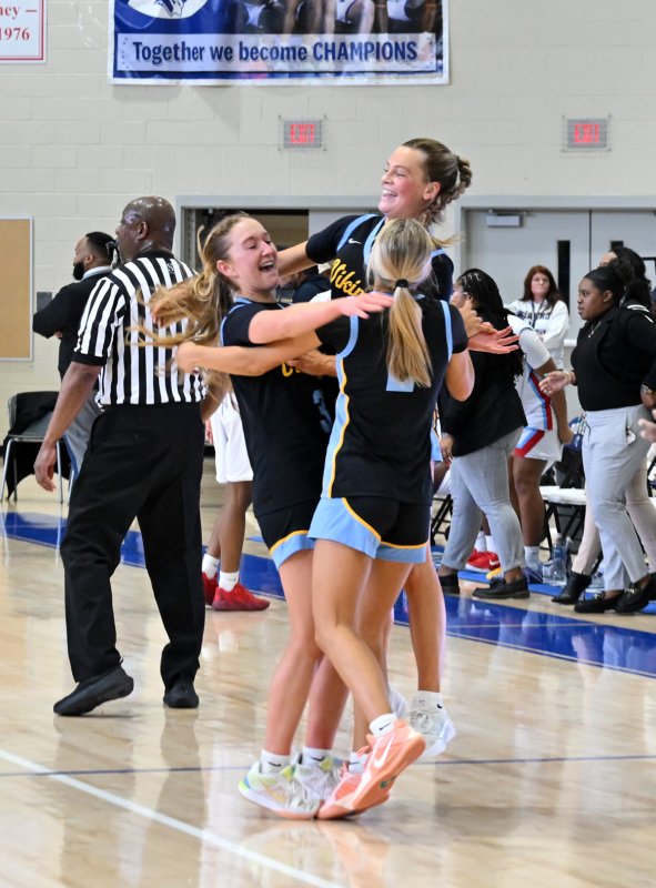 Giving each other a congratulatory hug at the final buzzer are (l-r) Mairead Rishko, Ally Diehl and Mikaela Gordon.