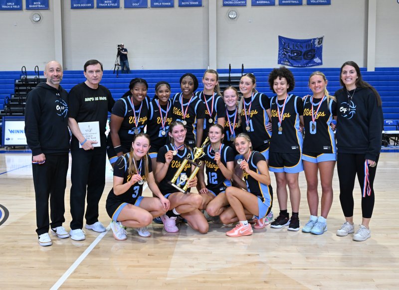 Posing with the Henlopen Conference trophy is the Cape team. Shown in back are (l-r) assistant coach John Gordon, head coach Ron Dukes, Jordynn Bowe, Natalie Horsey, Jurnee White, Ally Diehl, Sydney Whetzel, Maya Yngve, Erinn Rodriguez, Haley Gamuciello and assistant coach Sam Purple. In front are Mairead Rishko, Amalia Fruchtman, Amara Fruchtman and Mikaela Gordon.