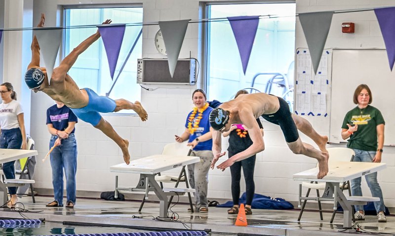 Friends Sussex Academy senior Christian Wright, left, and Cape junior Brady Schell leave the blocks in the 50 freestyle. Schell took first, while Wright finished second in the race.