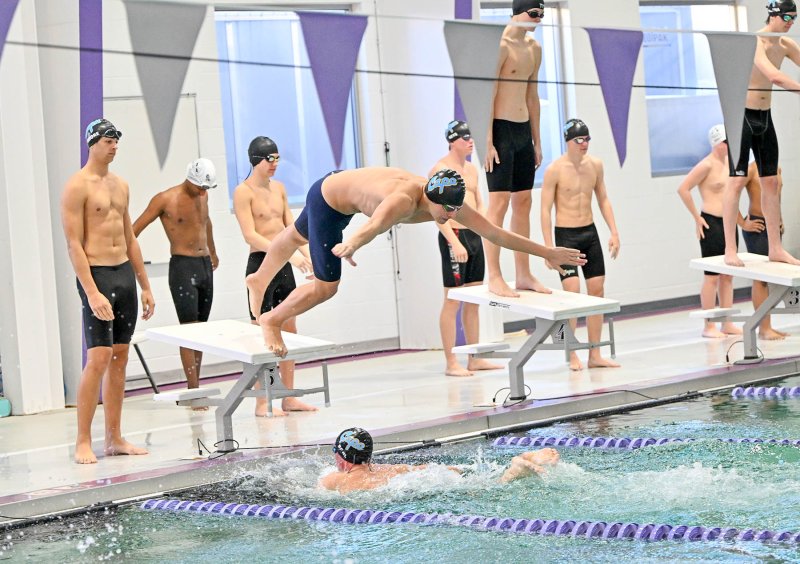 Cape’s Elijah Oliver leaves the blocks as Weston Bohl touches up in the 200 free relay.