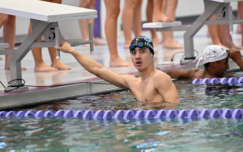 Cape senior Brooks Leonhartt looks at the scoreboard to see his winning time in the 100 breast.