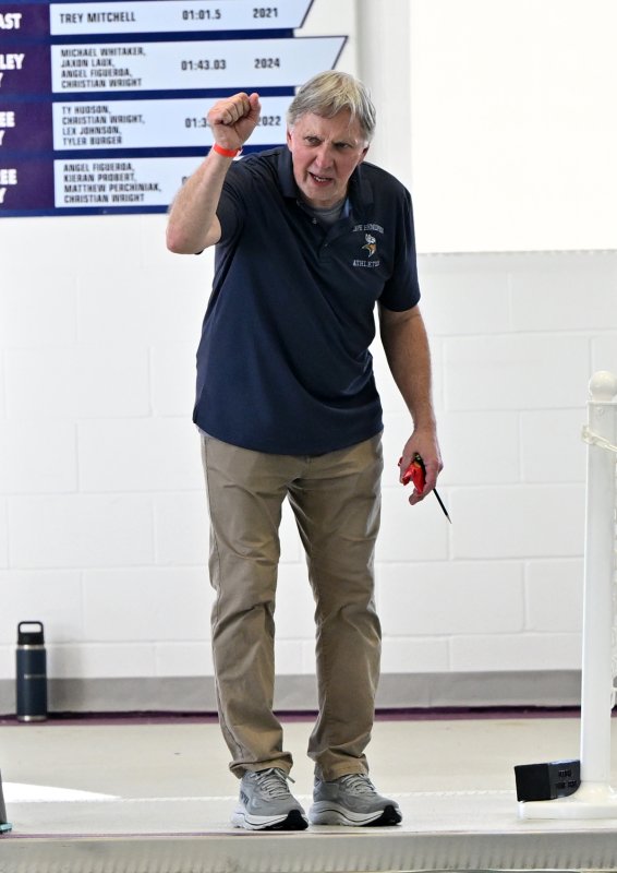 Cape coach Bill Geppert cheers on his girls’ 500 free swimmers.
