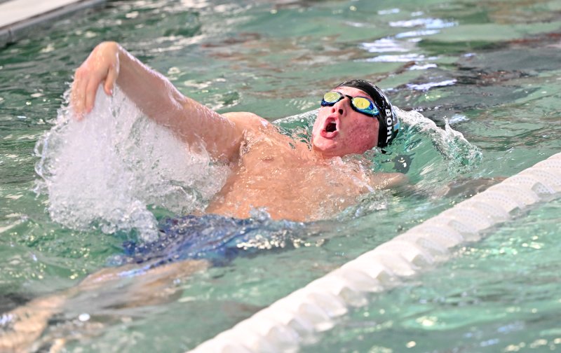 Weston Bohl swims to third in the 100 backstroke with a time of 59.87.