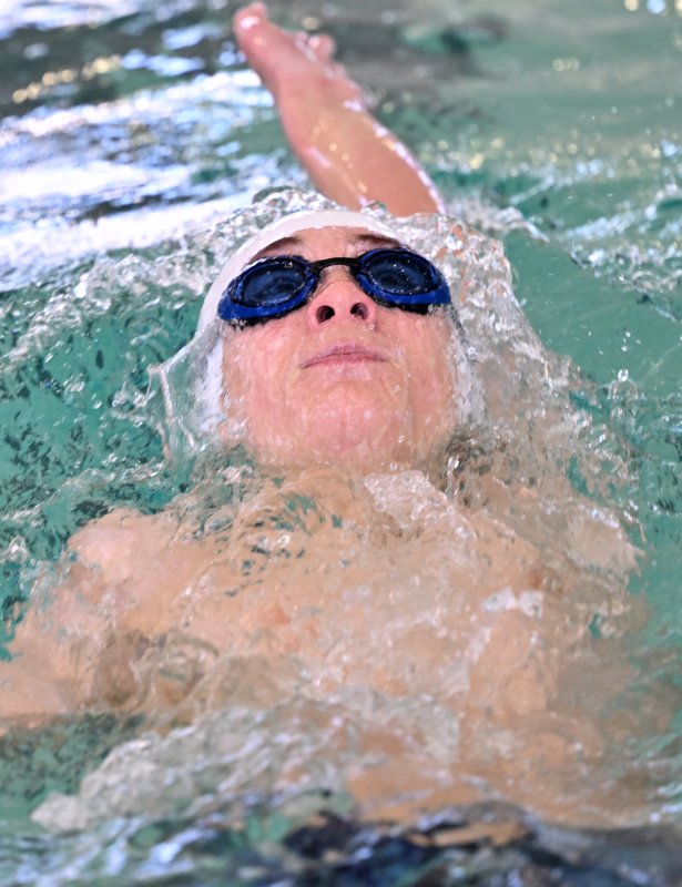 Sussex Academy eighth-grader Cale Argo swims to a time of 1:03.29 in the 100 backstroke.