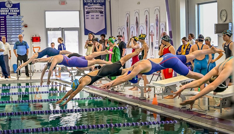 Competitors leave the blocks in thew 400 free relay.