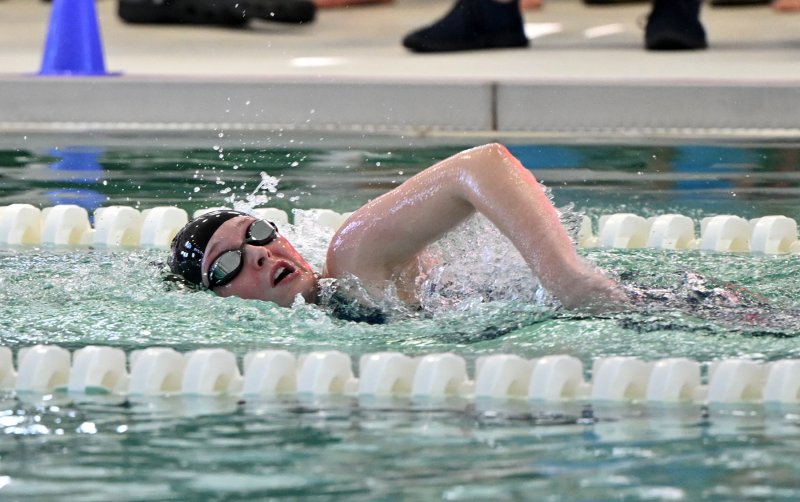 Milford senior Madi Stahl swims the first leg of the 400 free relay.