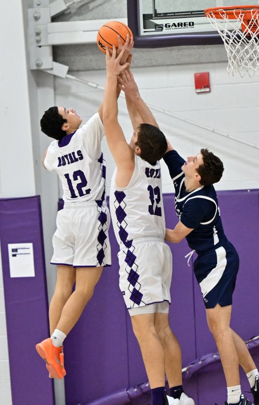 Aarin Tucker and Andrew Collins team for a rebound from the Sabres’ Robert Mangold.