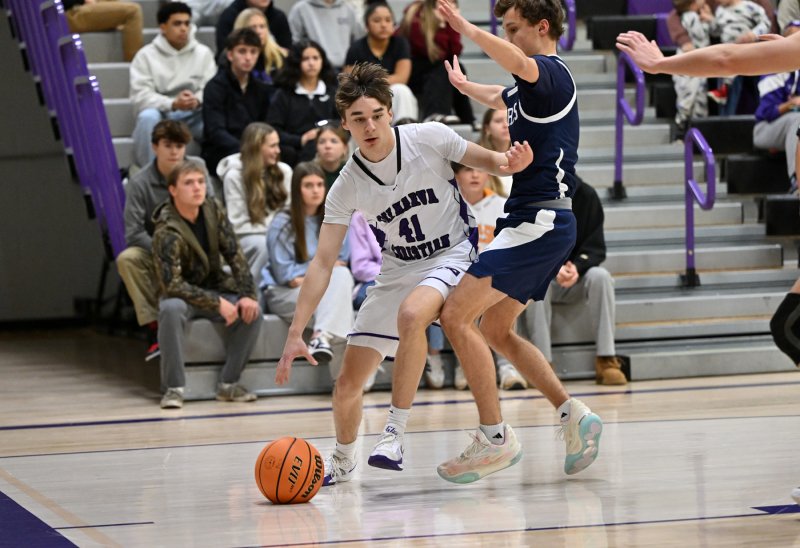 Royals sophomore Asher Woods drives the baseline.