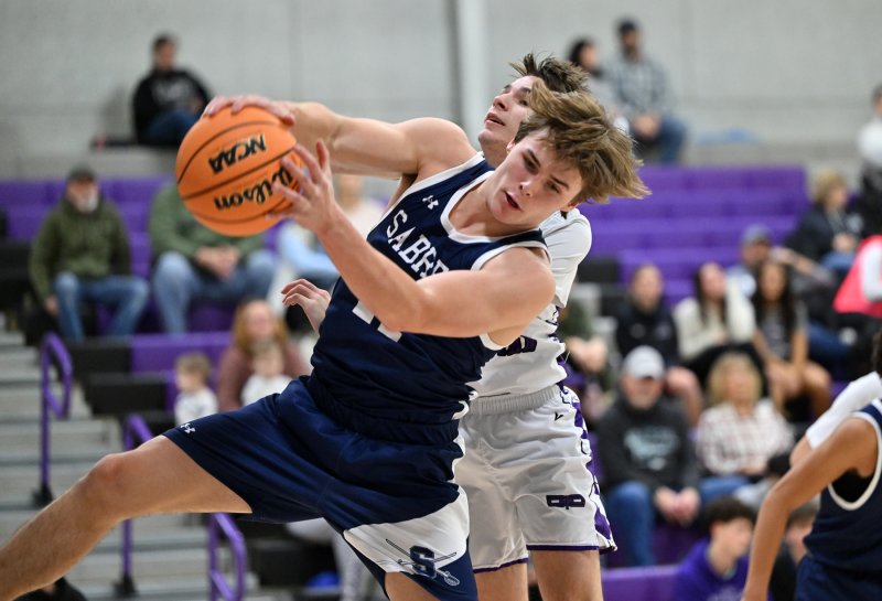 Sabres’ senior Porter Bishop yanks a rebound.