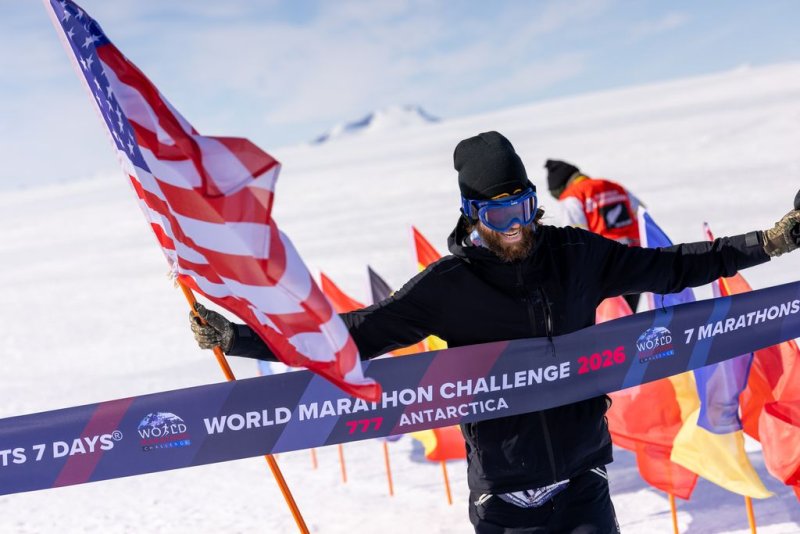 Local ultra-marathoner Mike Wardian crosses the finish line in Antarctica.
