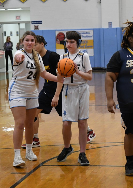Harlan Jones takes a shot with an assist from unified partner Brynne Fox.