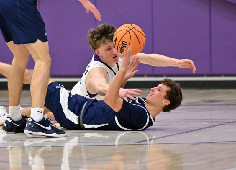 Royals junior Noah Barbrow battles for possession with the Sabres’ Peter Mangold.