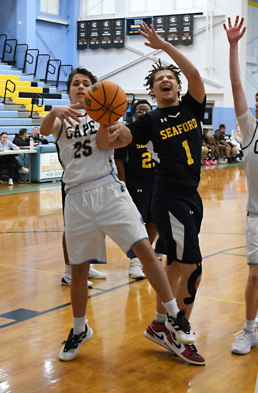 Sophomore Aiden Curran battles for possession with Seaford’s Timothy White.