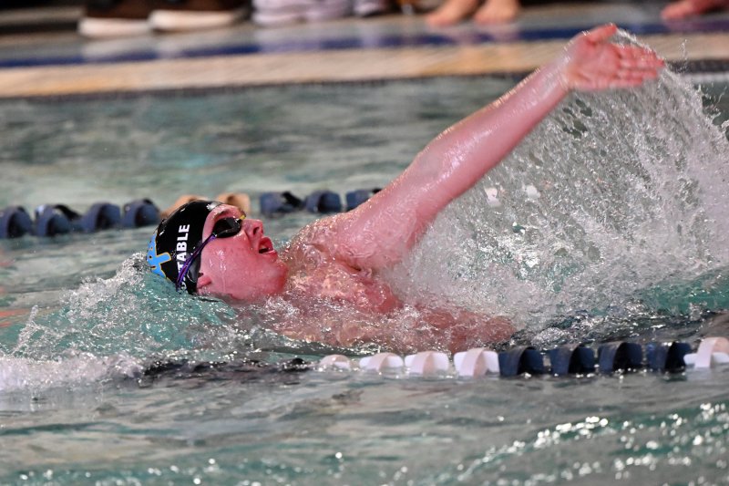 Cape’s Cole Huxtable swims the backstroke leg of the medley relay.