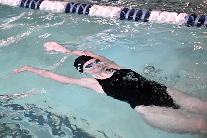 Cape sophomore Delaney Huxtable comes up after the flip in the backstroke.
