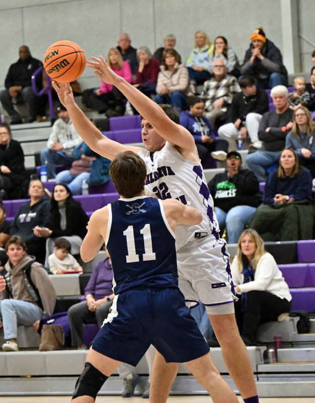 Royals senior Andrew Collins passes down low in the paint. He scored four points while grabbing six rebounds.