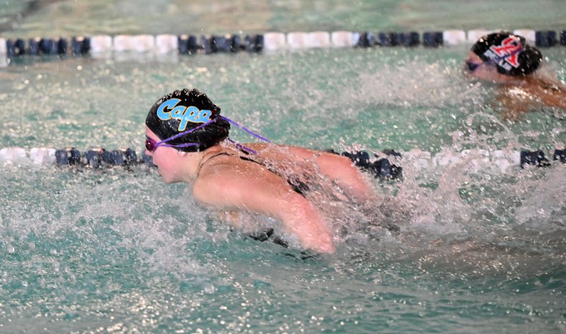 Cape freshman Lily Touw pulls ahead of her Ursuline opponent in the 100 fly.