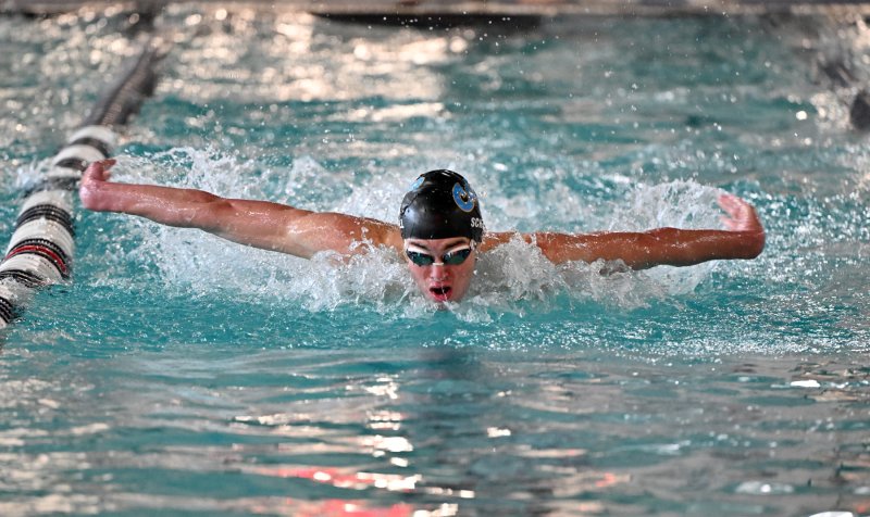 Cape junior Brady Schell swims the fly leg of the winning 200 medley relay team.