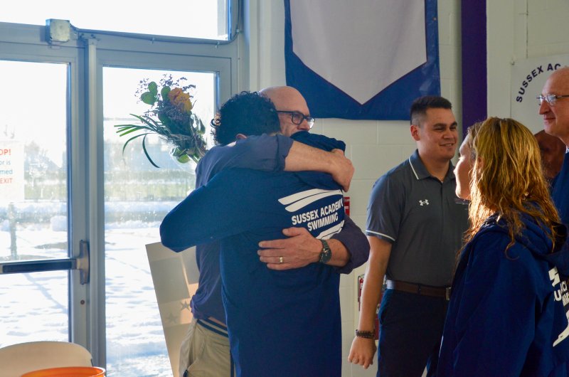 Seahawks coach Tom Martiner hugs one of his most decorated swimmers, Christian Wright.