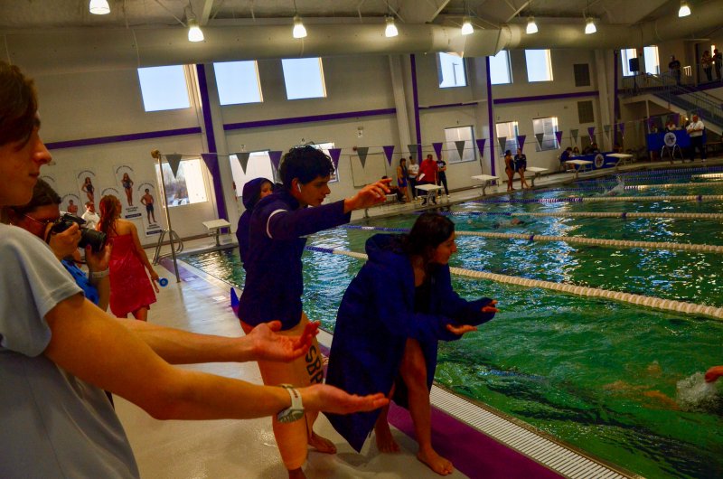 Sussex Academy senior Angel Figueroa and junior Camila Figueroa encourage Nolan Furlong in the 500.