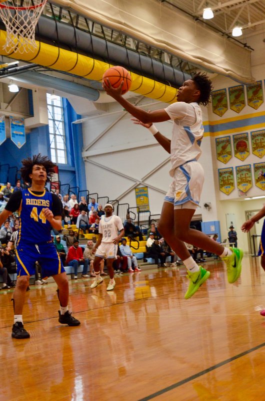 Vikings junior Geordan Downing finesses the ball up into the basket. AARON R. MUSHRUSH PHOTO