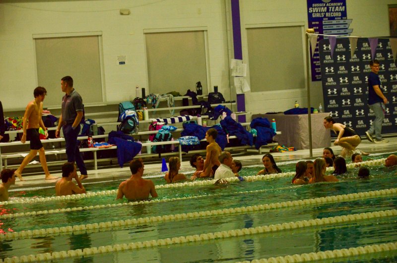 Swimmers and coaches take a dip following the end of the regular season.