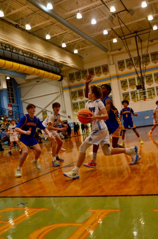 Fred Thomas seventh-grader James Frederick drives the baseline.