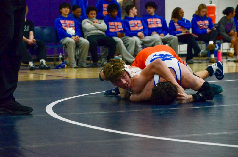 Sussex Academy junior Jeremy VanPelt looks over for advice.